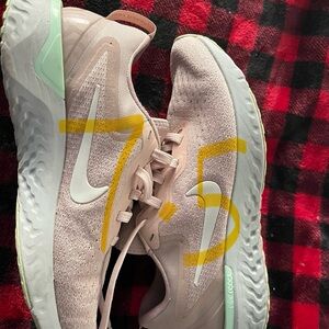 Light pink NIKE tennis shoes.